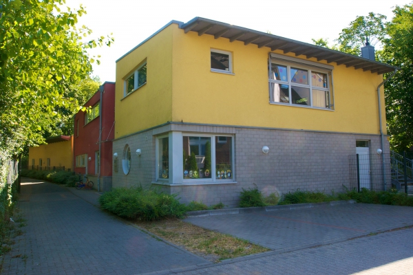 Das warme, sonnige Gelb und das moderne Terrakotta der KiTa -  Außenfassade bringen schon das Leben ins Haus.