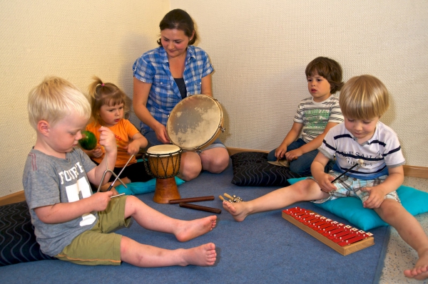 Die Kinder experimentieren mit unterschiedlichen Musikinstrumenten.